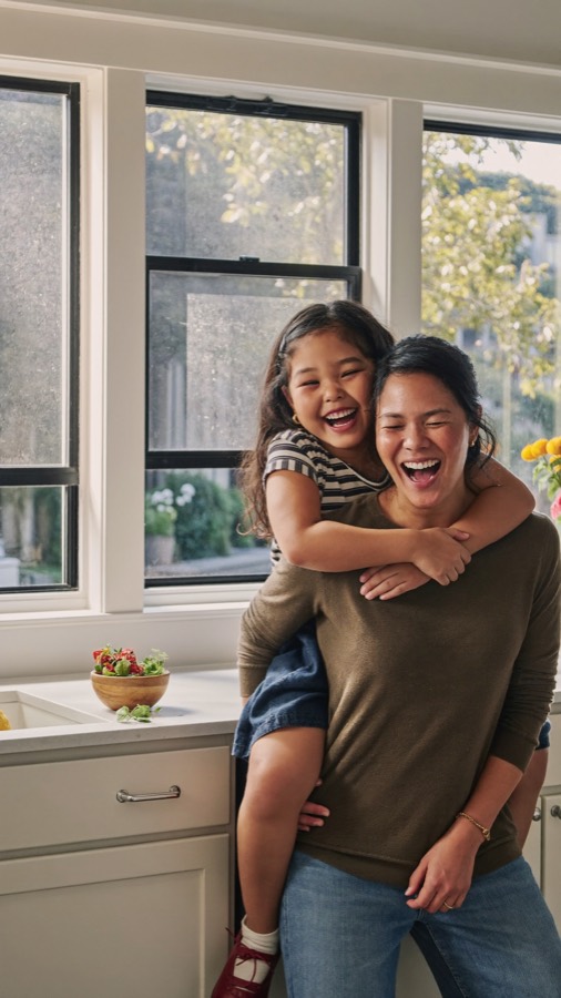 A mom giving her daughter a piggyback ride at home
